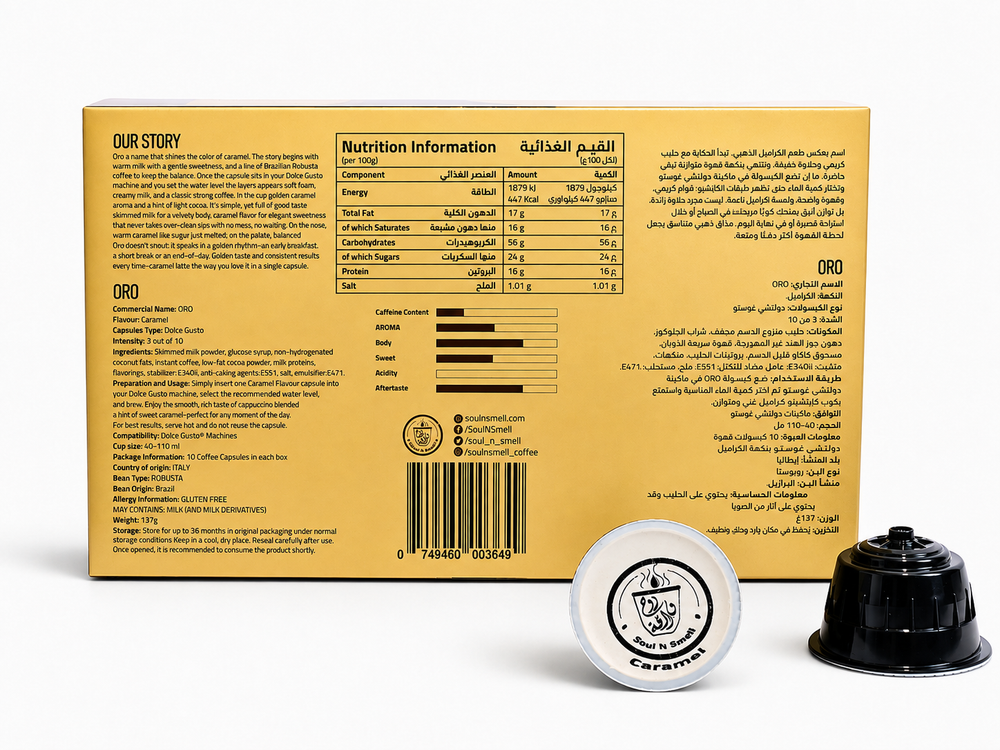 ORO - Caramel Cappuccino - A gold cardboard product box with printed nutrition information and text, shown alongside two coffee capsules on a white studio background. The capsules are one white with black printing and one black.