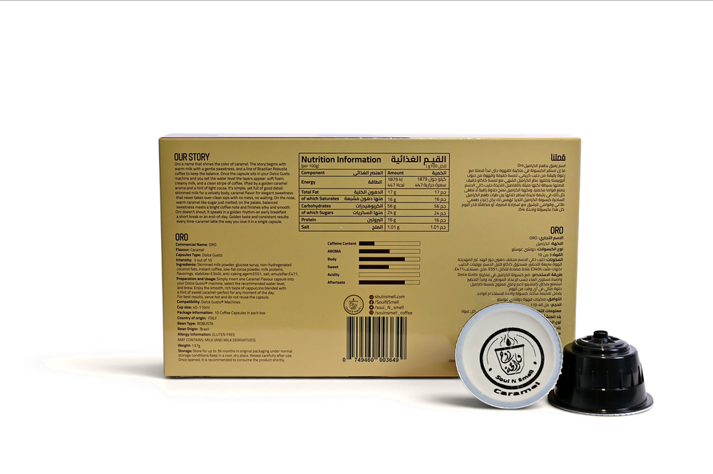 ORO - Caramel Cappuccino - A beige cardboard box with printed text and a barcode, shown on a white background alongside two coffee capsules, one silver and one black.